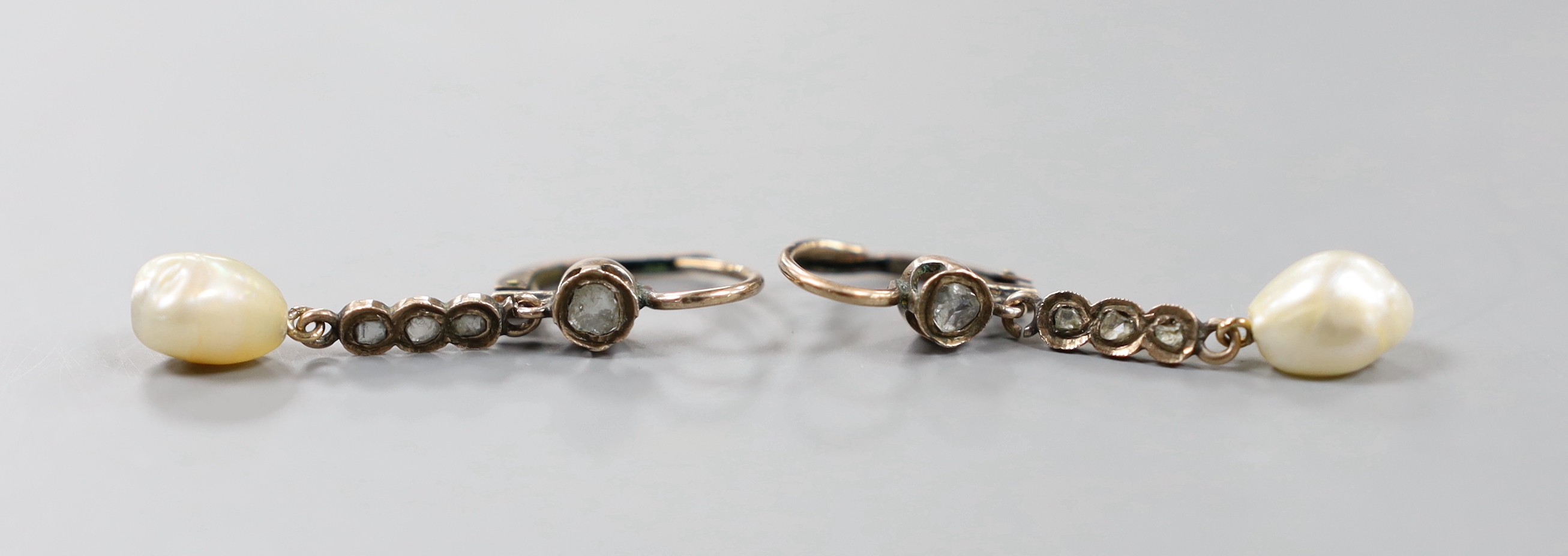 A pair of yellow metal, baroque pearl and rose cut diamond set drop earrings, 38mm and a similar pendant, gross weight 5.9 grams.